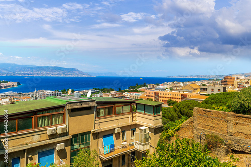panoramic summer travel view from a hill to  beautiful sea coast historical town with port, amazing ocean bay and gulf and beautiful mountains with scenic sunset on background. 