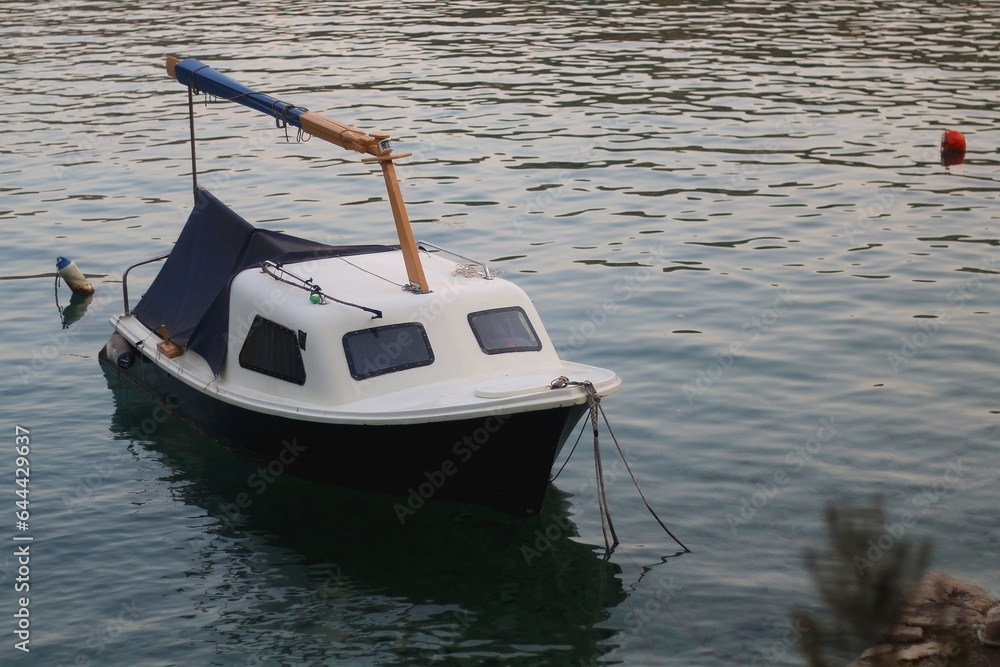 Small rustic boat on the promenade. Picturesque scene from Croatia.