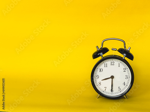 copy space for product display montage. , Ringing twin bell vintage classic alarm clock Isolated on yellow colourful trendy modern background.