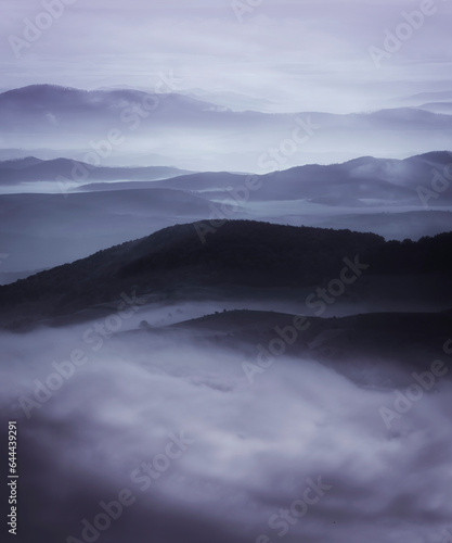 aerial view of fog covering hills, dark fantasy landscape © andreiuc88