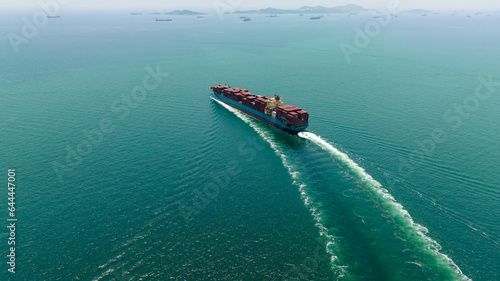 cargo container ship sailing full speed in sea to import export goods and distributing products to dealer and consumers worldwide, by container ship Transport business delivery service, aerial view