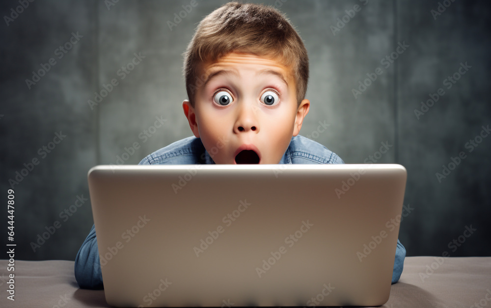 Shocked and surprised baby boy on the internet with laptop computer Shocked and surprised baby boy on the internet with laptop computer