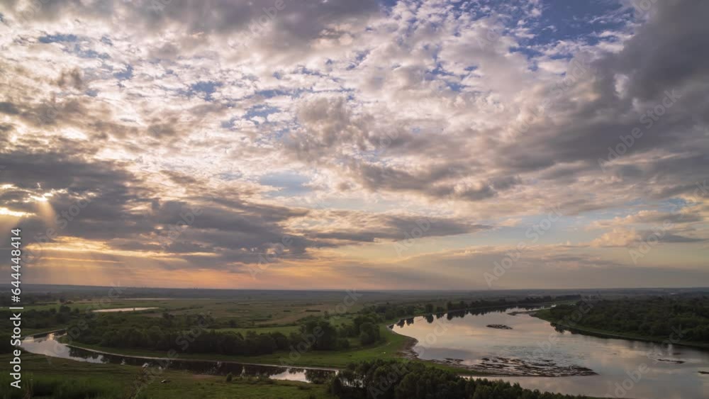 Beautiful morning landscape with summer forest and river. Timelapse sunrise over river. Beautiful sky with rolling clouds. Water surface in fast motion. Beautiful morning landscape with summer forest and river. Timelapse sunrise over river. Beautiful sky with rolling clouds. Water surface in fast motion.