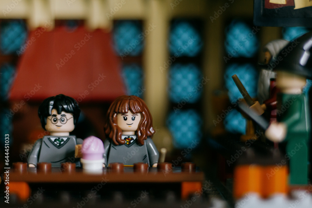 Naklejka premium Spain - 10 Sept 2023: Harry Potter and Hermione Granger Lego figures in the Great Hall of Hogwarts.