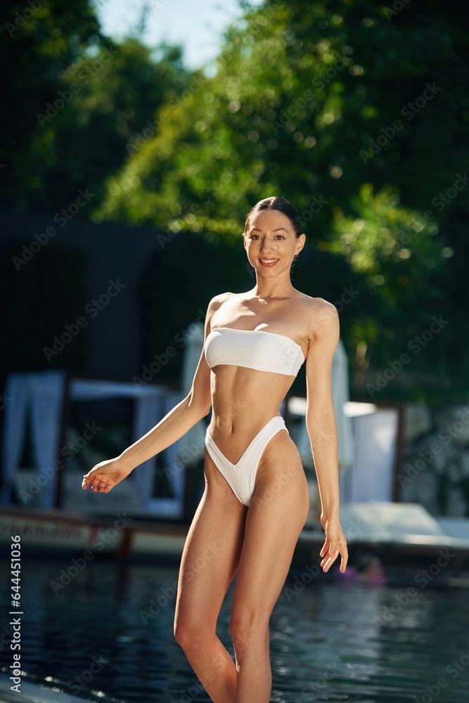 White underwear. Woman is standing near the pool White underwear. Woman is standing near the pool