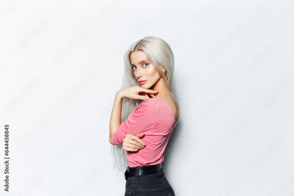 Studio portrait of pretty blonde girl in pink shirt on white background. Studio portrait of pretty blonde girl in pink shirt on white background.