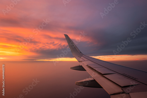 Wing of airplane in colorful sunset