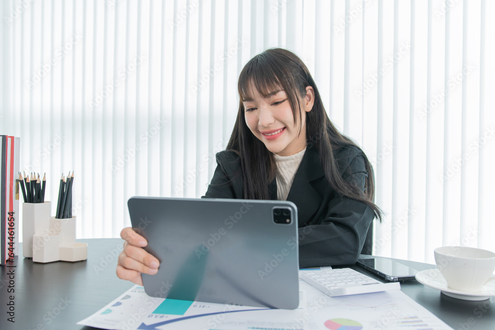 business woman working on the tablet ,discussing customer and checking business analytic document report working place in office. business woman working on the tablet ,discussing customer and checking business analytic document report working place in office.