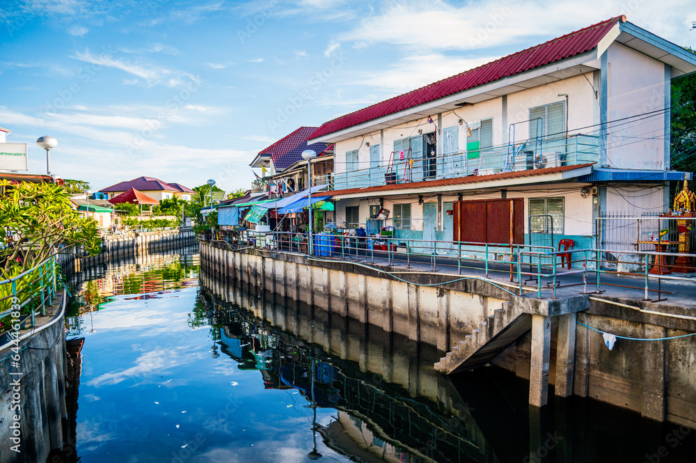 The canal drains water into the sea, on both sides of the canal there are houses of the people at Ban Na Kluea, Pattaya, Thailand.