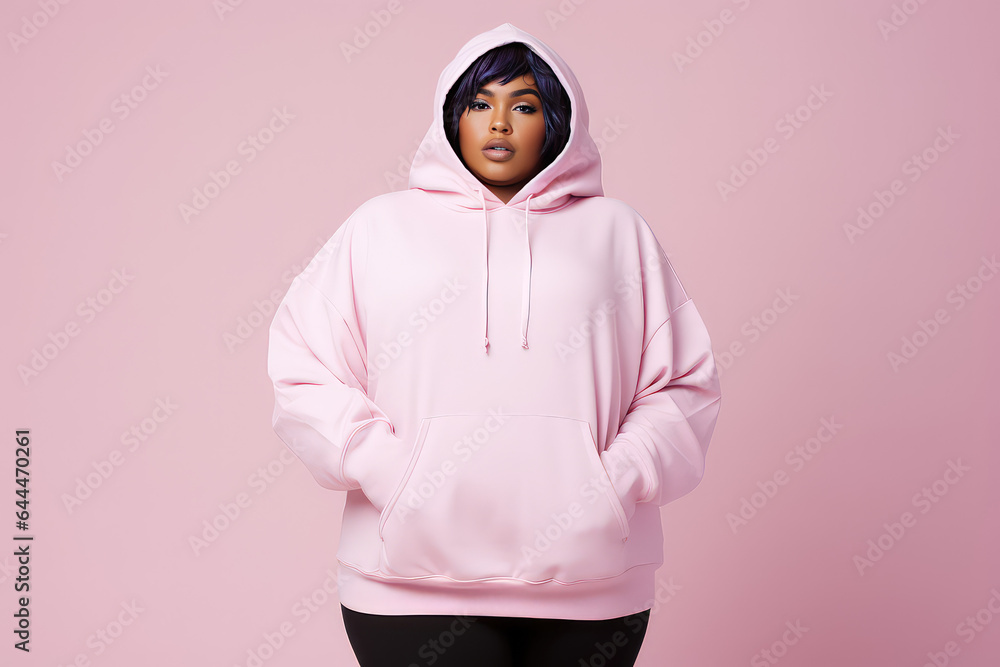 Full body portrait of plus size model woman wearing sport hoody on flat pink background, copy space. Store sportswear of all sizes, bodypositive. Full body portrait of plus size model woman wearing sport hoody on flat pink background, copy space. Store sportswear of all sizes, bodypositive.