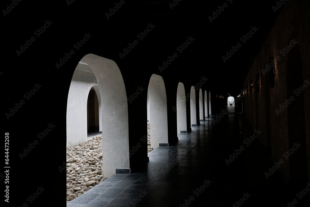 Light shining through traditional arch window hallway