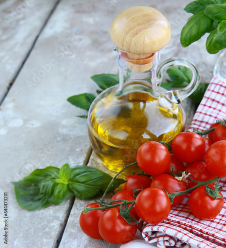 fresh organic tomatoes and basil on wooden background