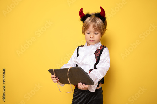 4 years old boy with Halloween costume on pink background - Halloween concept.