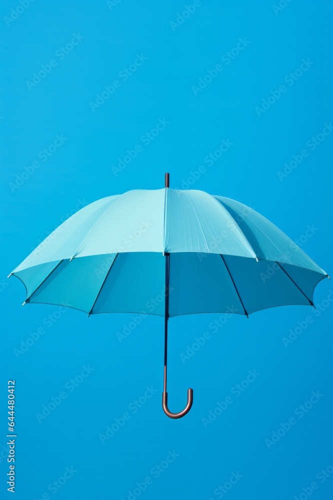 A striking blue umbrella set against a blue backdrop, encapsulating minimalistic design. Ideal for themes around weather, protection, or simplicity