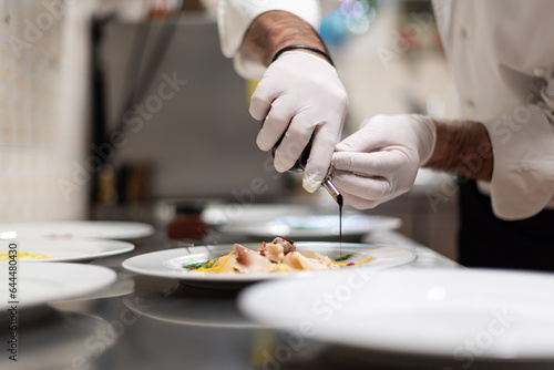 final touch on fish carpaccio, Italian restaurant Cooking