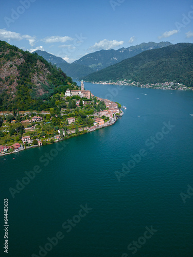 Lake Lugano between italy and switzerland, deep blue lake, day off, yachts on the water, beautiful view, drone footage