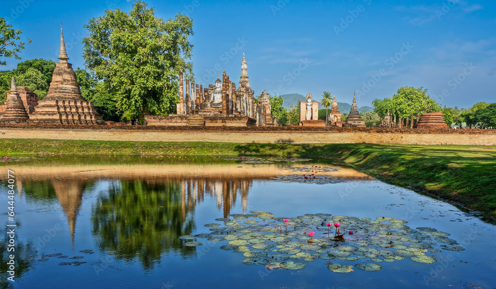 Naklejka premium Wat Mahathat Buddhist temple in Sukhothai historical park. UNESCO and World Heritage Site. Culture and vacation concept.
