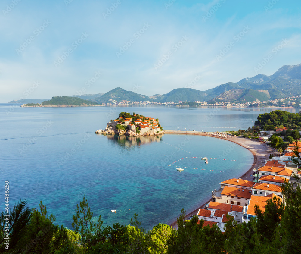Fototapeta premium The morning view of Sveti Stefan sea islet with pink beach (Montenegro, near Budva). People are unrecognizable.