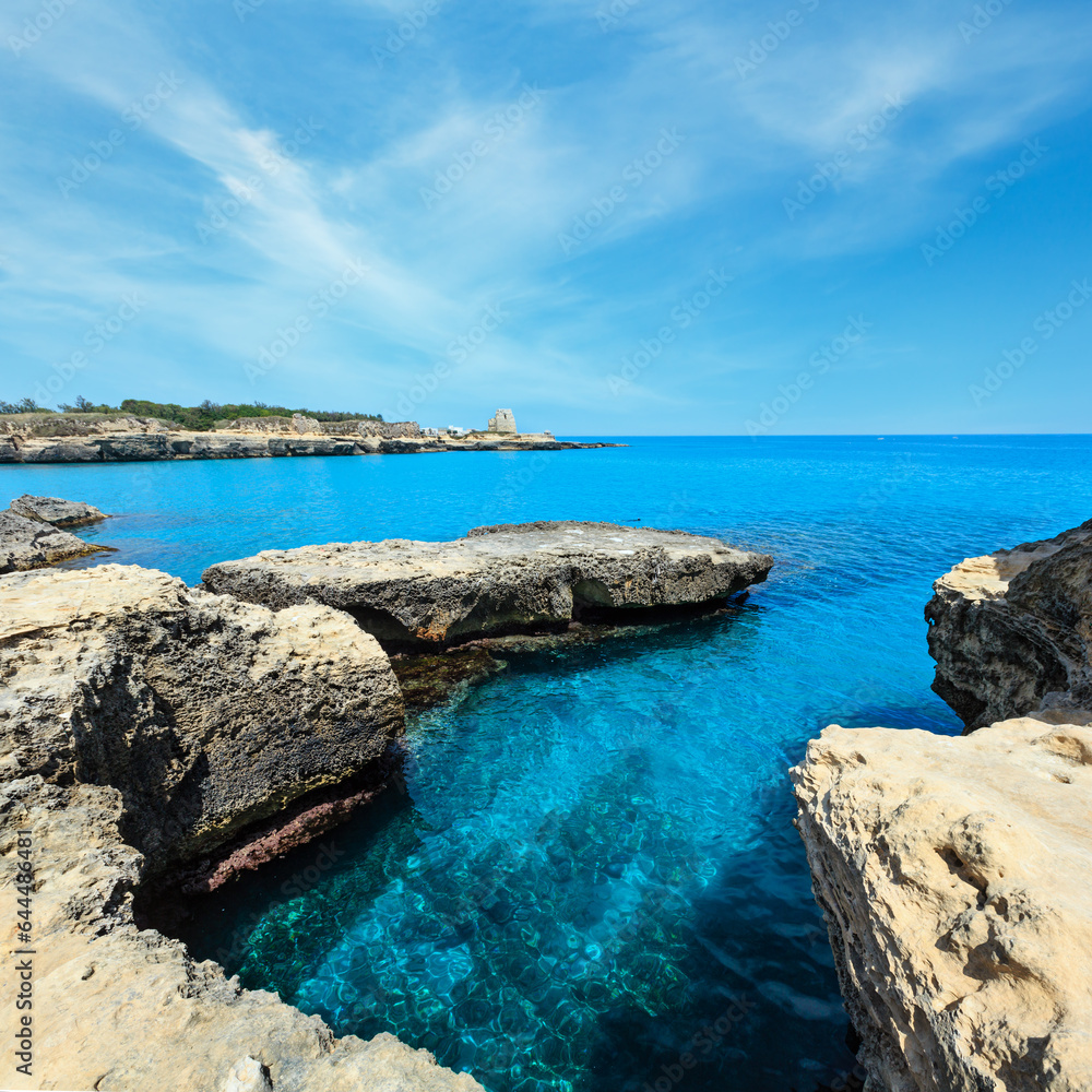 Picturesque seascape with white rocky cliffs, caves, sea bay and islets at Grotta della poesia, Roca Vecchia, Salento Adriatic sea coast, Puglia, Italy