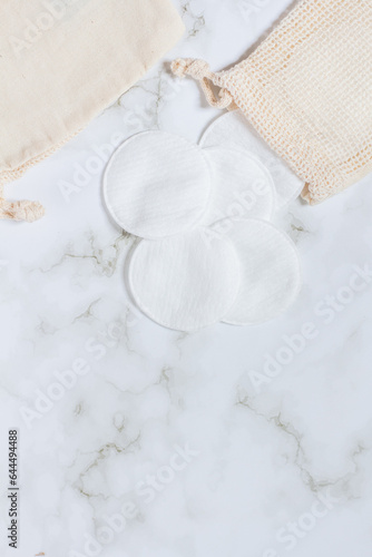 Soap and cotton pads on marble background.