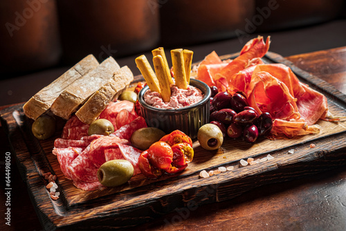 meat plate with ovives and white wine photo