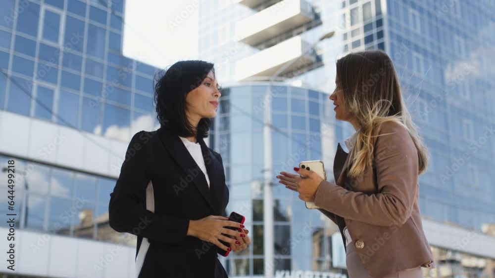 Business partners meet and chat outdoors. Business partners meet and chat outdoors.