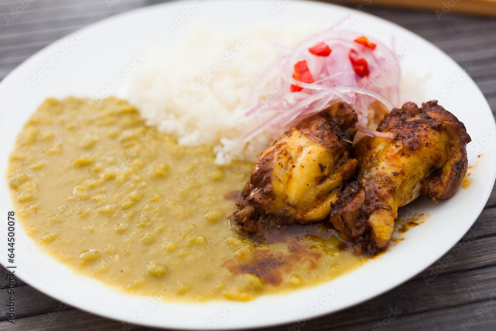 Traditional Peruvian dish. chicken wings with pea puree, rice and pickled onions Traditional Peruvian dish. chicken wings with pea puree, rice and pickled onions