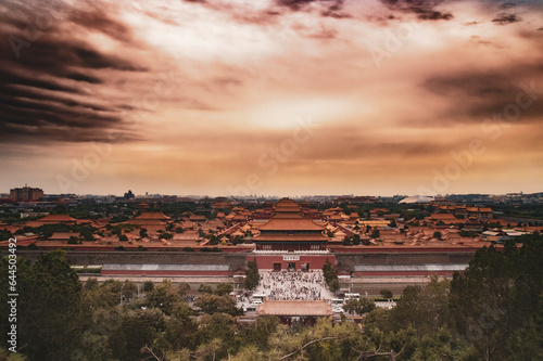 A view over forbidden city in bejing china. From the top of the hill in Jingshan park. Sunset in the sky over the old chinese city photo