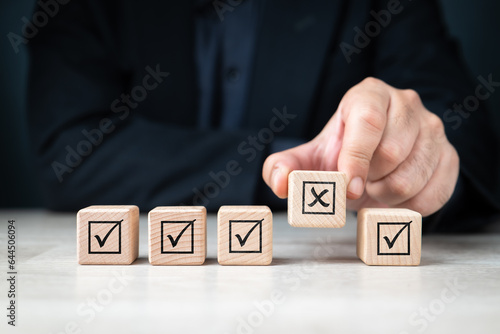 The man behind the wood cubes chooses the wrong one even though there are many correct ones in a row, bad luck, probability, detect error, mistake, and wrong selection