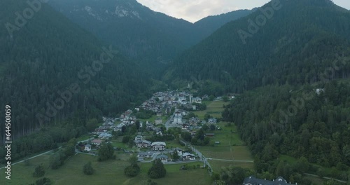 Aerial view of Nebbiu, a small town on the mountain crest on the Dolomites Mountains at sunset, Veneto, Belluno, Italy. photo