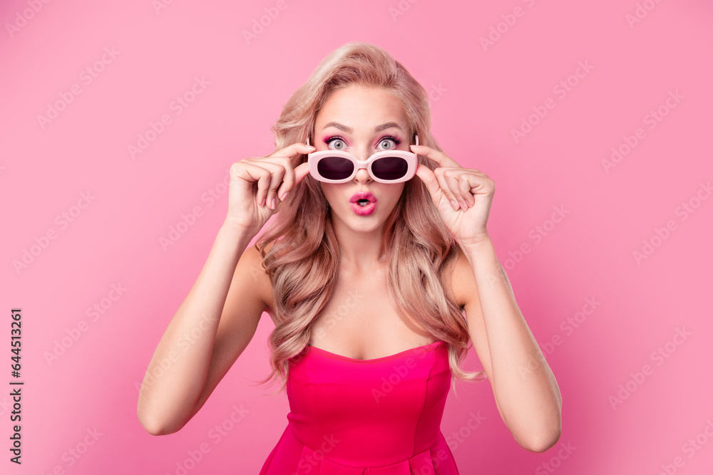 Portrait of impressed nice person arms touch sunglass pouted lips cant believe isolated on pink color background Portrait of impressed nice person arms touch sunglass pouted lips cant believe isolated on pink color background