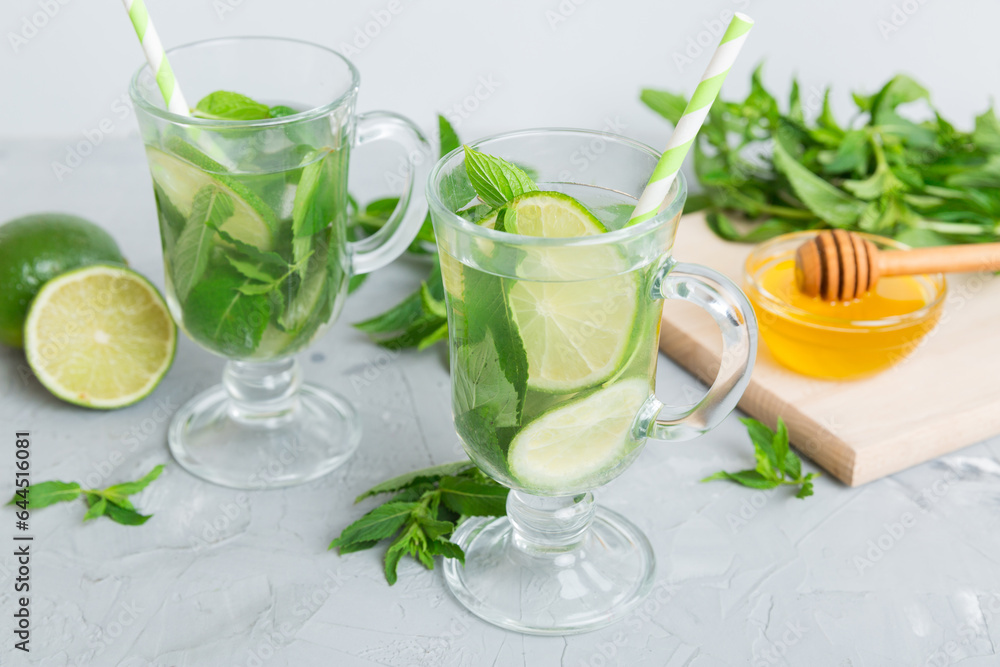 Mojito cocktail. Refreshing mojito cocktail with lime, lemon and mint in a tall glass with a stick Mojito cocktail. Refreshing mojito cocktail with lime, lemon and mint in a tall glass with a stick