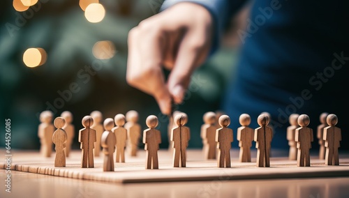 Wooden figures of people stand on a chessboard. The concept of leadership.