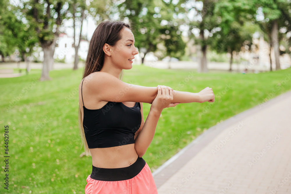 caucasian young woman stretching exercises in the park. healthy lifestyle concept. caucasian young woman stretching exercises in the park. healthy lifestyle concept.