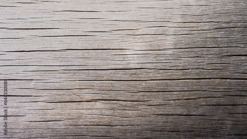 Fototapeta premium The texture, rough, and patterned, is characteristic of wooden planks, in rural areas.