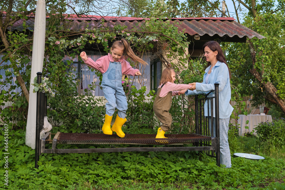 Nature and Nurture: As the greenery takes over the man-made structure, two girls find harmony in their playful endeavors, demonstrating how nature and nurture can coexist. Nature and Nurture: As the greenery takes over the man-made structure, two girls find harmony in their playful endeavors, demonstrating how nature and nurture can coexist.