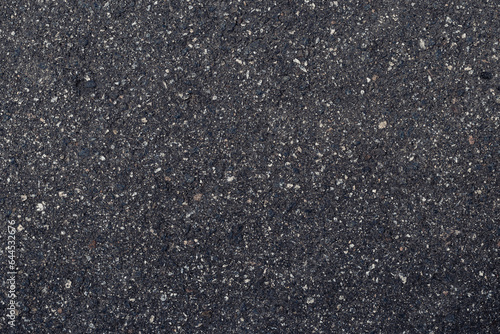 Fototapeta Naklejka Na Ścianę i Meble -  Surface grunge rough of asphalt, dark grainy road close-up, black texture background with small rocks, top view.