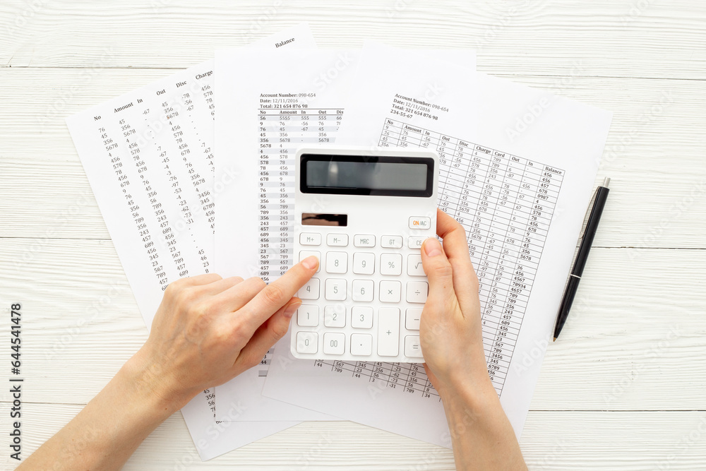 Financial business report preparing with calculator on office table Financial business report preparing with calculator on office table