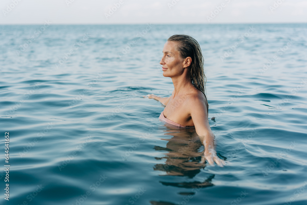 Blissful woman swimming in the sea in pleasure. Blissful woman swimming in the sea in pleasure.
