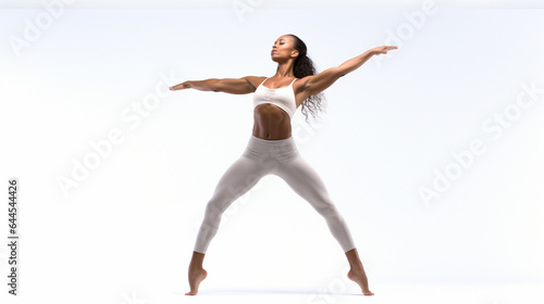 Photo of a woman gracefully performing a yoga pose on a serene white background