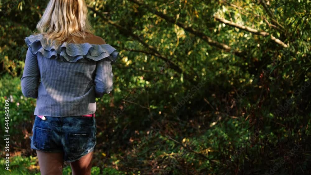 Attractive woman walking through forest Attractive woman walking through forest