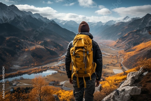 A traveler with a yellow backpack explores stunning mountain vistas