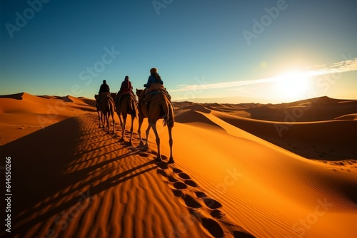 Wide angle shot of a camel caravan crossing Sahara Deserts sand dunes