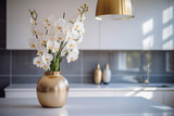 Beautiful orchid flowers in vase on table in kitchen