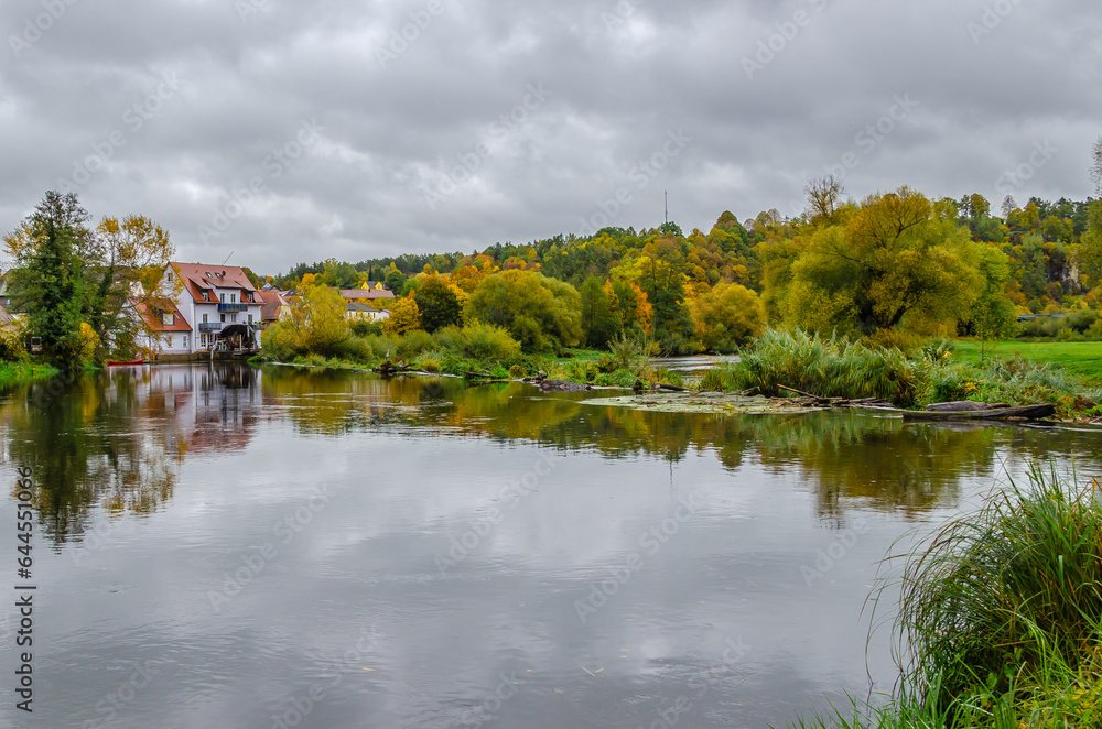 Kallmünz, Germany -  River Naab in autumn with town houses in background