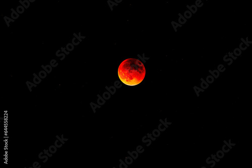 Blood moon total eclipse over Flagstaff Arizona with black sky and stars