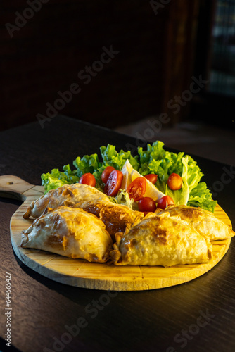 typical argentinian empanadas . large argentinian empanadas on black background