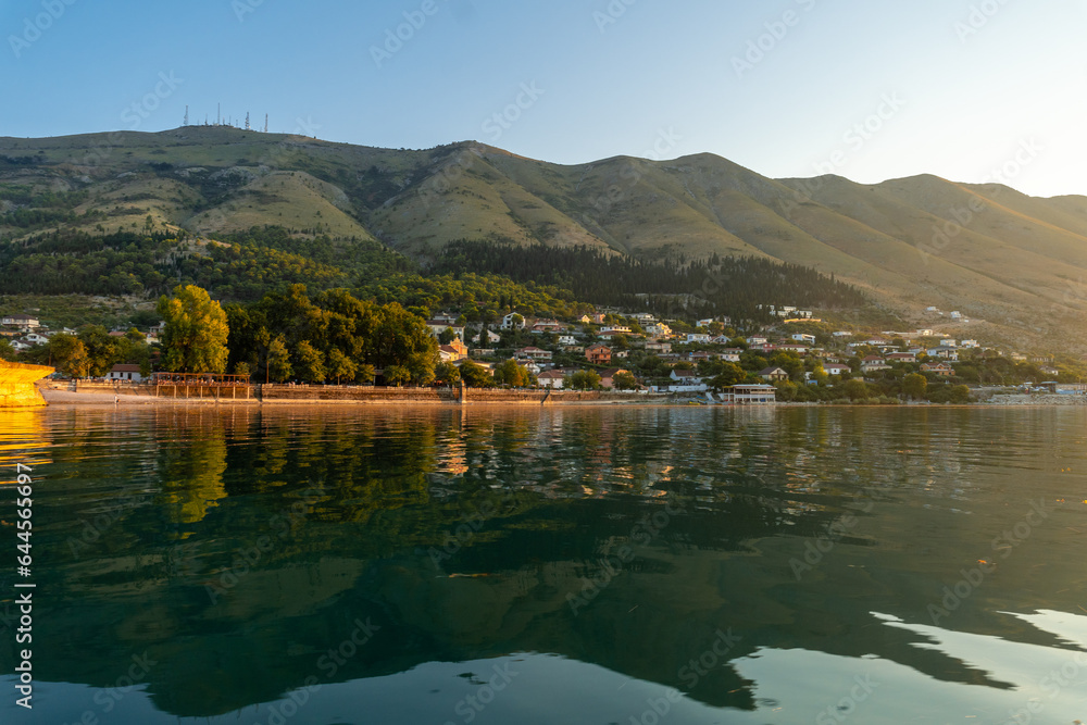 View of the city of Shiroka from the lake on a traditional boat on a sightseeing excursion from Shkoder. Albania
