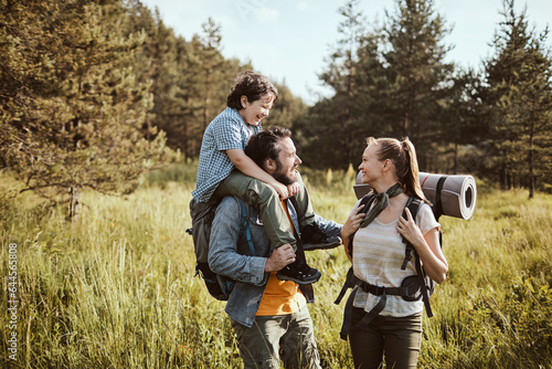 Young family hiking in the forest and mountains