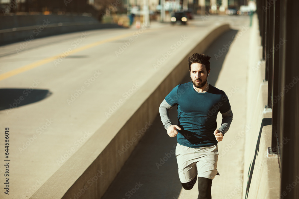 Young man sprinting and exercising on a bridge in the US